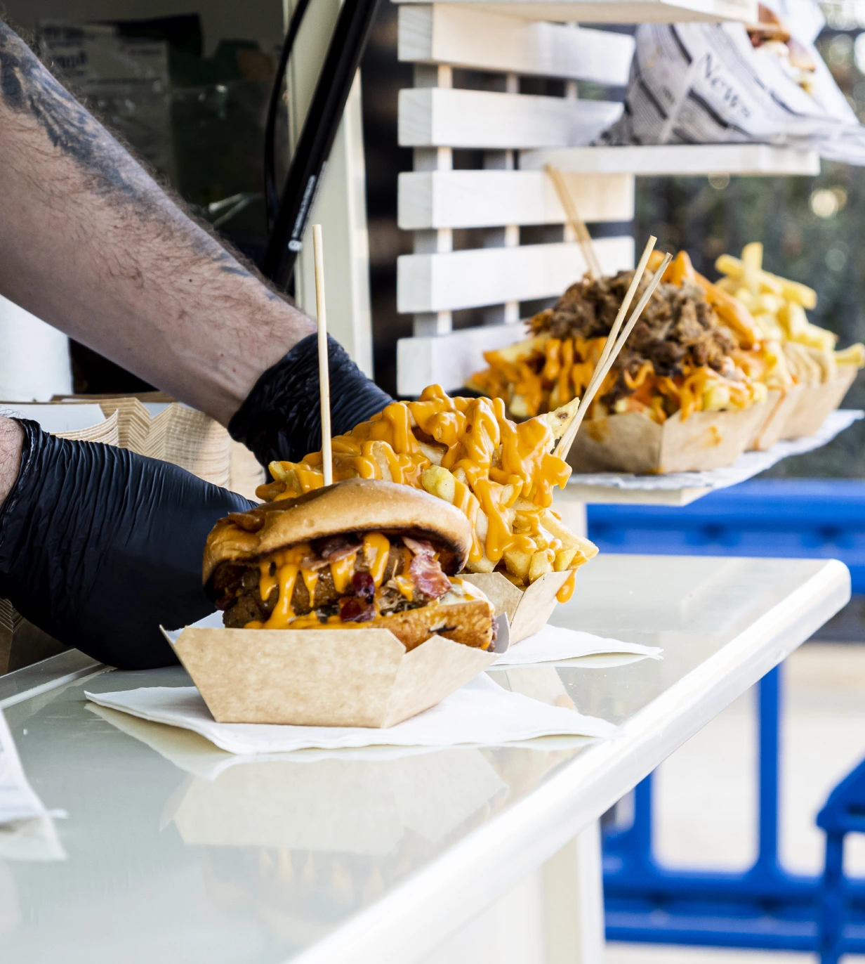 A person holding onto a tray of food